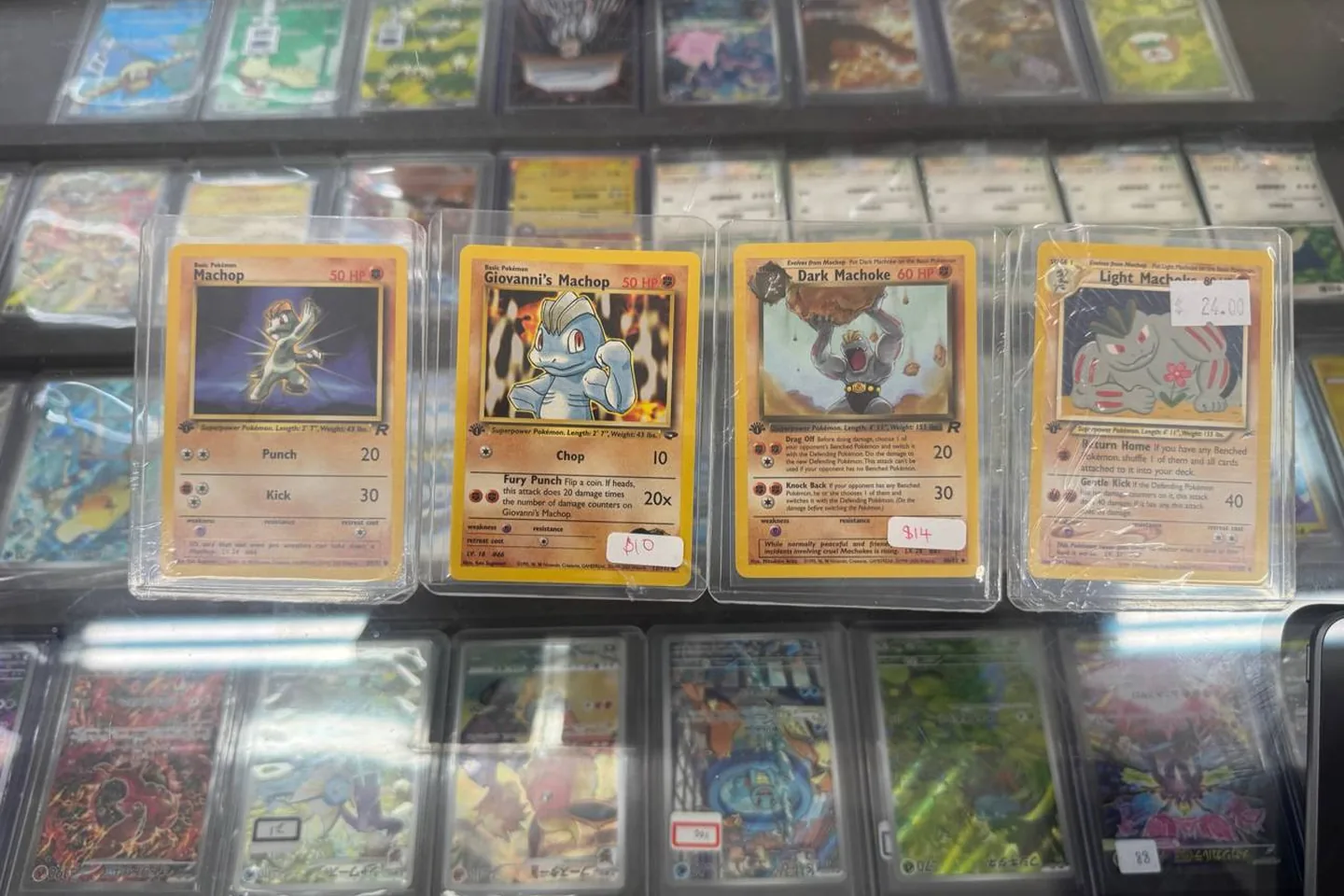 Two collectors smiling with a Charizard card pull.